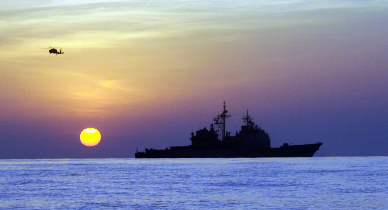 A grey US Navy guided-missile cruiser on counter-piracy patrol in the open waters of the Gulf of Aden