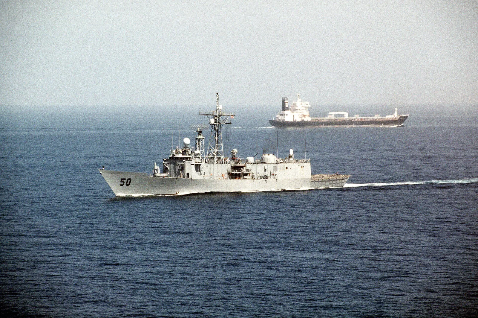 U.S. frigate USS Taylor sailing past a tanker after transiting the Strait of Hormuz