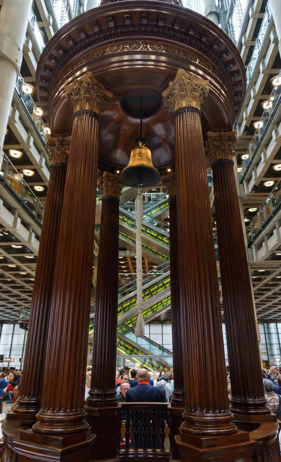 The historic Lutine Bell hanging above the wooden rostrum in the underwriting room of the Lloyd's building