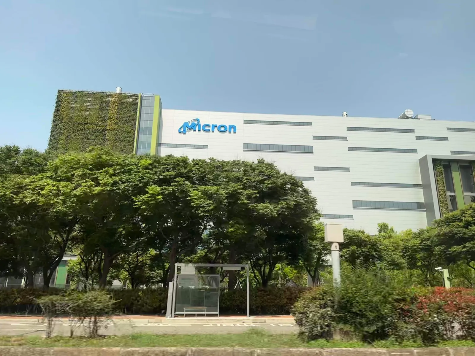 Memory-chip maker Micron's fab building in Taichung, Taiwan, with trees and a road in front