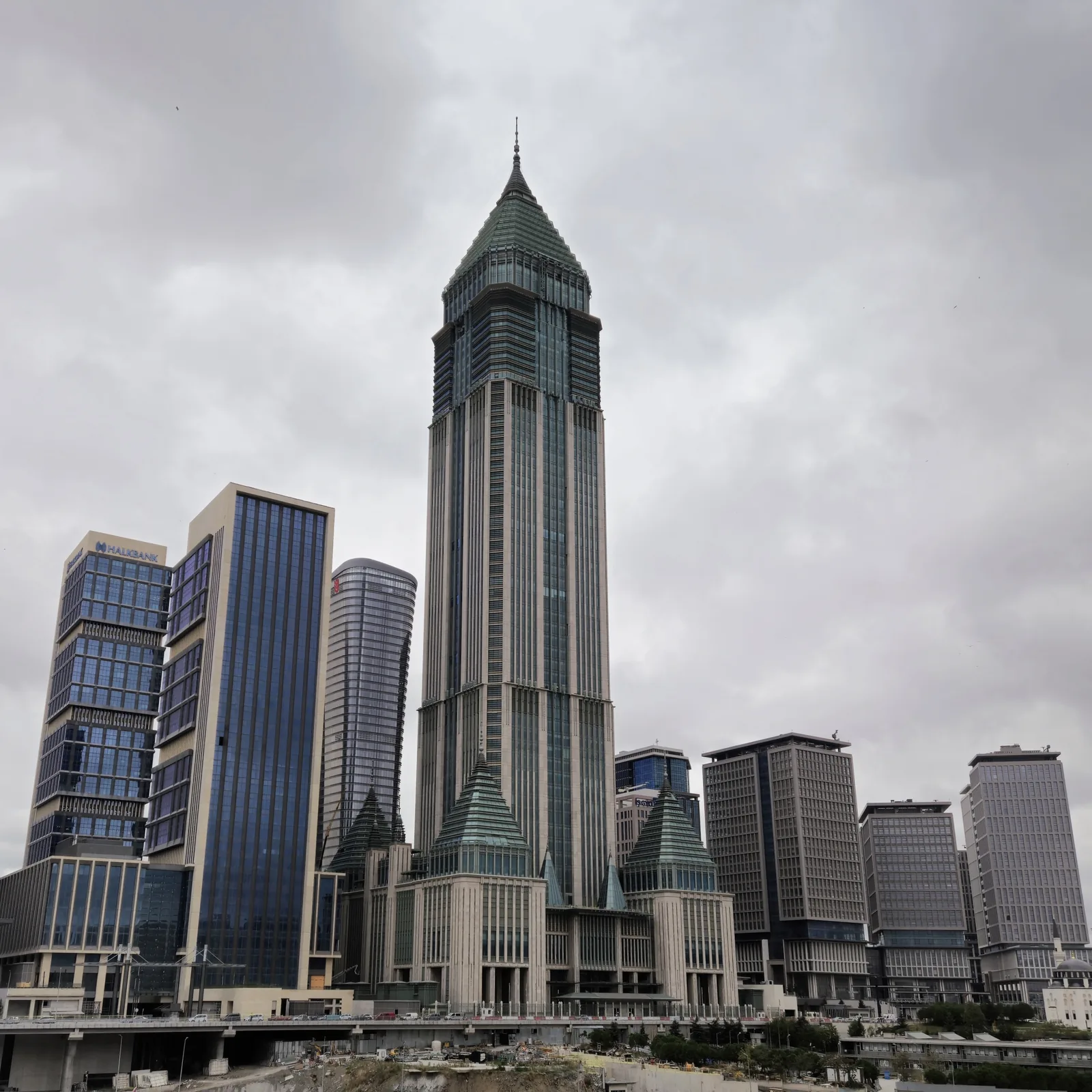 The spire-topped CBRT Tower and surrounding office blocks at the Istanbul Financial Center under a cloudy sky